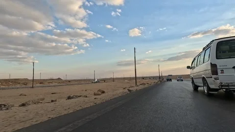 Long peaceful road trip through Cairo Fayoum Desert Road desert highway scenery Stock Footage 330070574