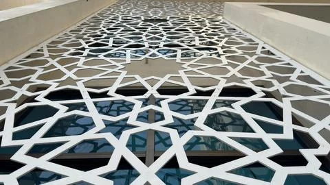 A long perspective view of an exterior wall covered with an elaborate white g Stock Photos