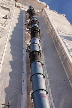 A long pipe on the building to throw away building debris Stock Photos