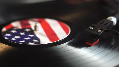 Long Play Vinyl Record With American Flag Spinning Under Needle of Turntable Stock Footage 337624338