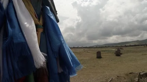 Long prayer blue flags flutter in the wind at a Buddhist monastery in column Stock Footage 54648944