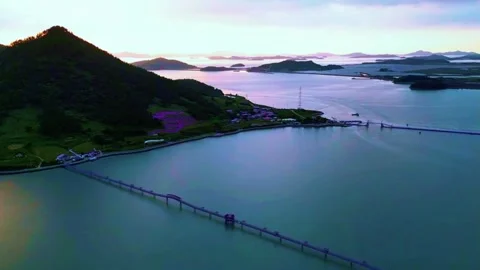 Long Purple Bridge Spanning Across the Open Sea Between Islands Stock Footage 328241574
