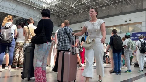 Long Queue at Airport Check-In During Busy Travel Season in Bright Terminal Stock Footage 318411071