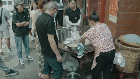 Long queue of Asian people waiting for street food Stock Footage 221694918