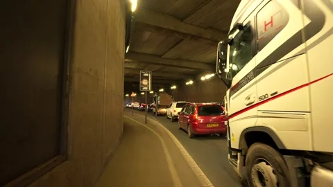 A long queue of cars polluting a long road traffic tunnel Stock Footage 271181382