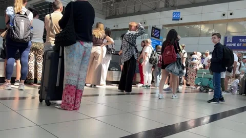 Long Queue Forms at Airport Check-In Counter During Busy Travel Hours Stock Footage 318411048