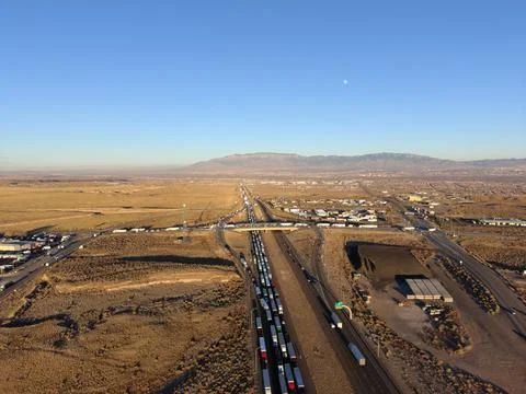 Long Queue of Freight Trucks on Highway Aerial Drone Landscape Stock Photos