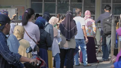 Long queue of patients queuing for health services at a hospital outpatient.. Stock Footage 242225157