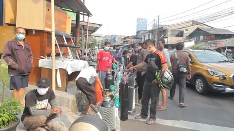 LONG QUEUE OF PEOPLE TO BUY OKSIGEN TUBE AT JAKARTA Stock Footage 157157367