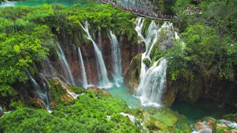 Long queue of people hiking on narrow path in Plitvice Lakes National Park Stock Footage 265905727