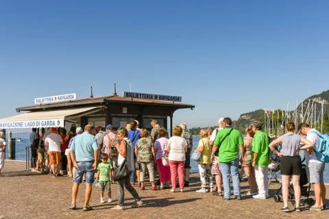 Long queue of people queuing to buy tickets for a ferry in Lake Garda Stock Photos