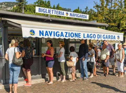 Long queue of people queuing to buy tickets for a ferry in Lake Garda Stock Photos