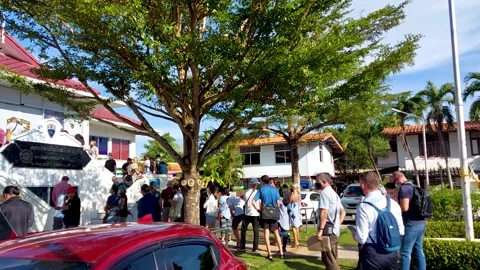 A long queue stands outside at the Phuket immigration office Stock Footage 170118300