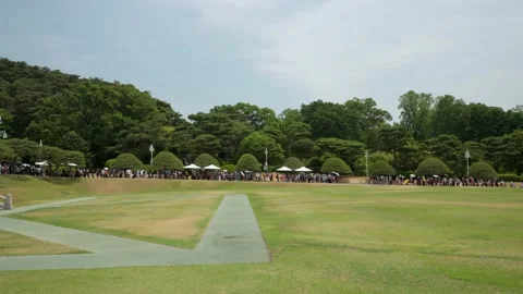 A long queue of tourists waiting in line to enter Main Office Hall Stock Footage 197347794