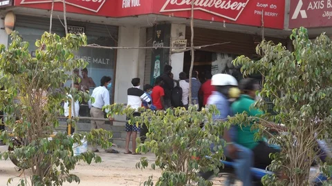 Long queues infront of liquor shops Stock Footage 129773538