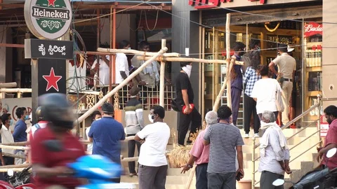 Long queues infront of liquor shops Stock Footage 129778663
