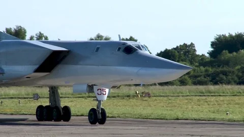 Long-range bomber Tu-22M3 taxis on taxiway in direction of parking. Stock Footage 111313347
