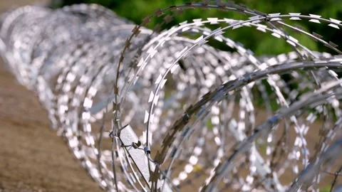 Long Razor Wire Barrier Receding in Perspective, Stable Shot Stock-Footage 344121759