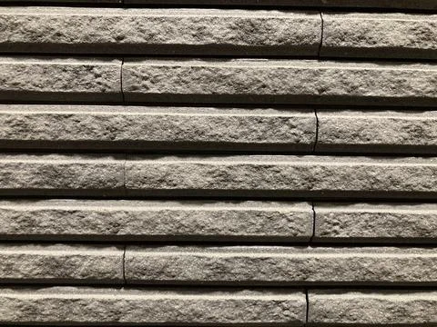 A long rectangular gray concrete wall in a full-frame shot Stock Photos