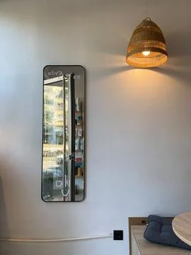 Long rectangular mirror with handwritten text on cafe wall Stock Photos