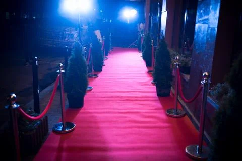 Long red carpet between rope barriers on entrance. Stock Photos