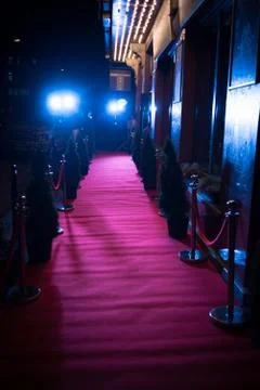 Long red carpet between rope barriers on entrance. Stock Photos