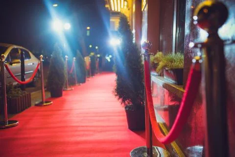 Long red carpet between rope barriers on entrance. Stock Photos