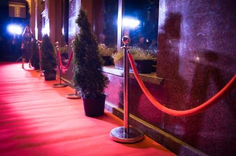 Long red carpet between rope barriers on entrance. Stock Photos