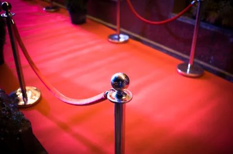 Long red carpet between rope barriers on entrance. Stock Photos
