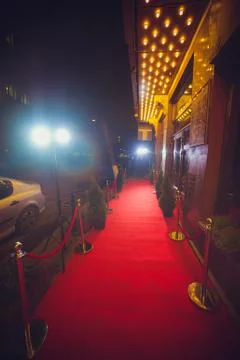 Long red carpet between rope barriers on entrance. Stock Photos