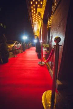 Long red carpet between rope barriers on entrance. Stock Photos
