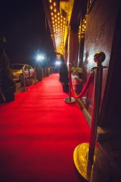 Long red carpet between rope barriers on entrance. Stock Photos