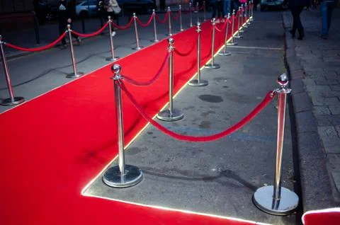 Long red carpet between rope barriers on entrance. Stock Photos