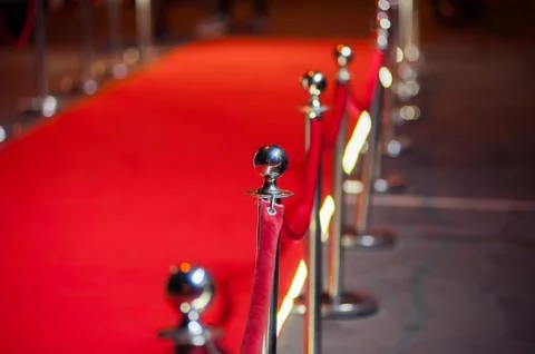 Long red carpet between rope barriers on entrance. Stock Photos