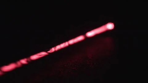 Long Red Laser Beam with Dust Particles on Black Background Stock Footage 267055727