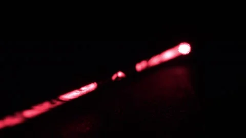 Long Red Laser Beam from Laser Pointer, Rack Focus, Black Background Stock Footage 267055707