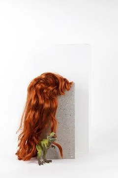 Long red wig cinder block and trex Stock Photos