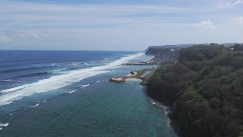 Long reef waves along Bukit Peninsula cliffs near Bali beaches and blue lagoons Stock Footage 315508713