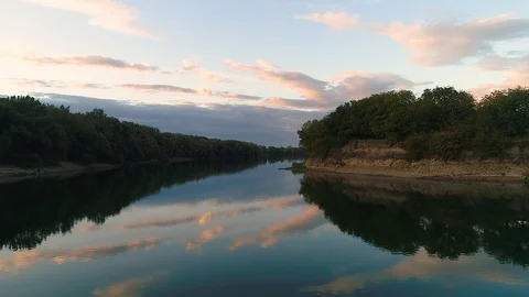 A long river curve with lines of trees on it's coasts. Stock Footage 113069945