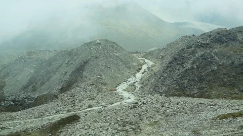 Long river flowing through two mountains on a foggy day Stock Footage 77450775