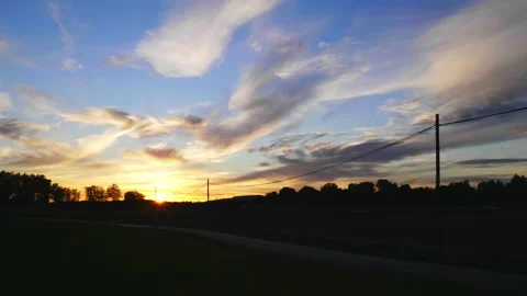 Long road and trees view during sunset. Beautiful sky and cloud  Stock Footage 179803916