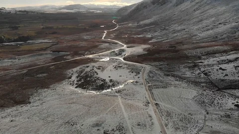 Long road at the base of snowy mountain. Stock Footage 102335341