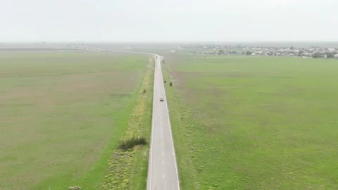 Long road between green field in crimea Stock Footage 153518982