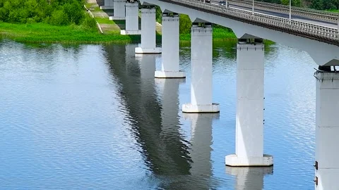 Long road bridge connects the two banks of a large and beautiful river Stock Footage 306548865