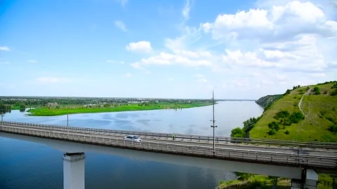 Long road bridge connects the two banks of a large and beautiful river Stock Footage 306548911