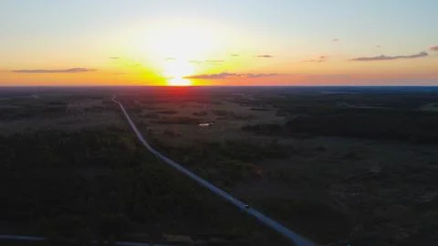 Long road in endless sunset Stock Photos