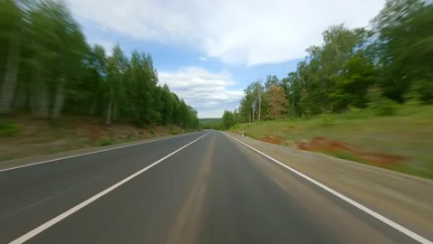 Long road with a hard surface. The route is among dense forests and hills. Long Video stock 157997923