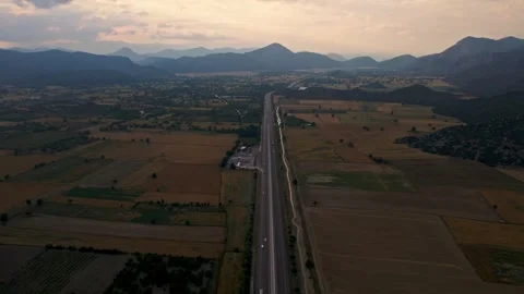 A long road runs through a field of crops Stock Footage 327913761