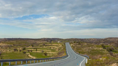 Long road through a hills Stock Footage 339056632