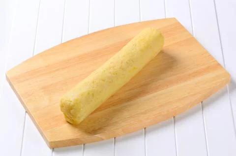 Long roll-shaped potato dumpling ready to be cut into slices Stock Photos